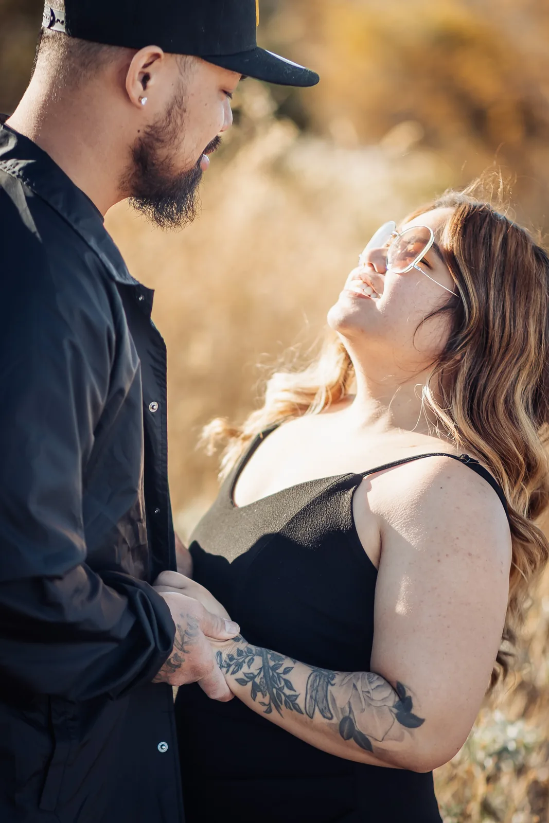 Couple backlit by the low sun, the woman smiling up at her partner in Summerlin