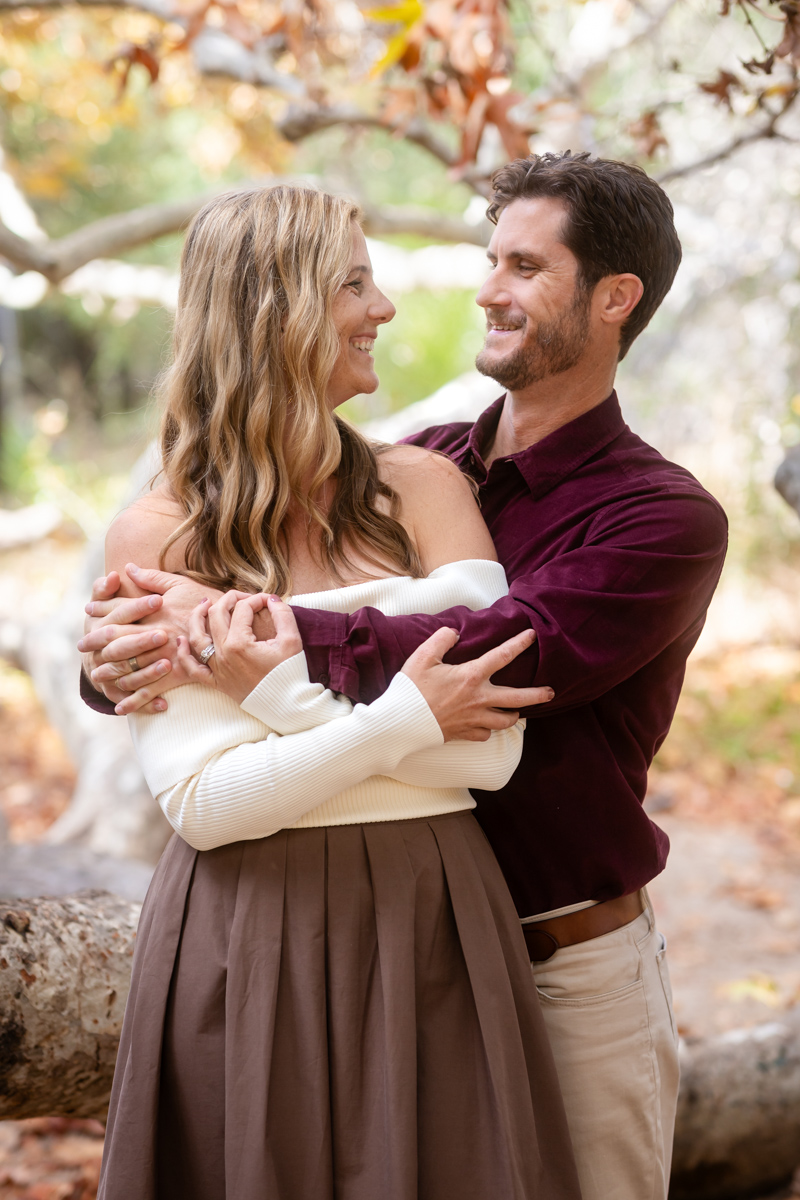 Engaged couple embracing during golden hour outdoors in Las Vegas