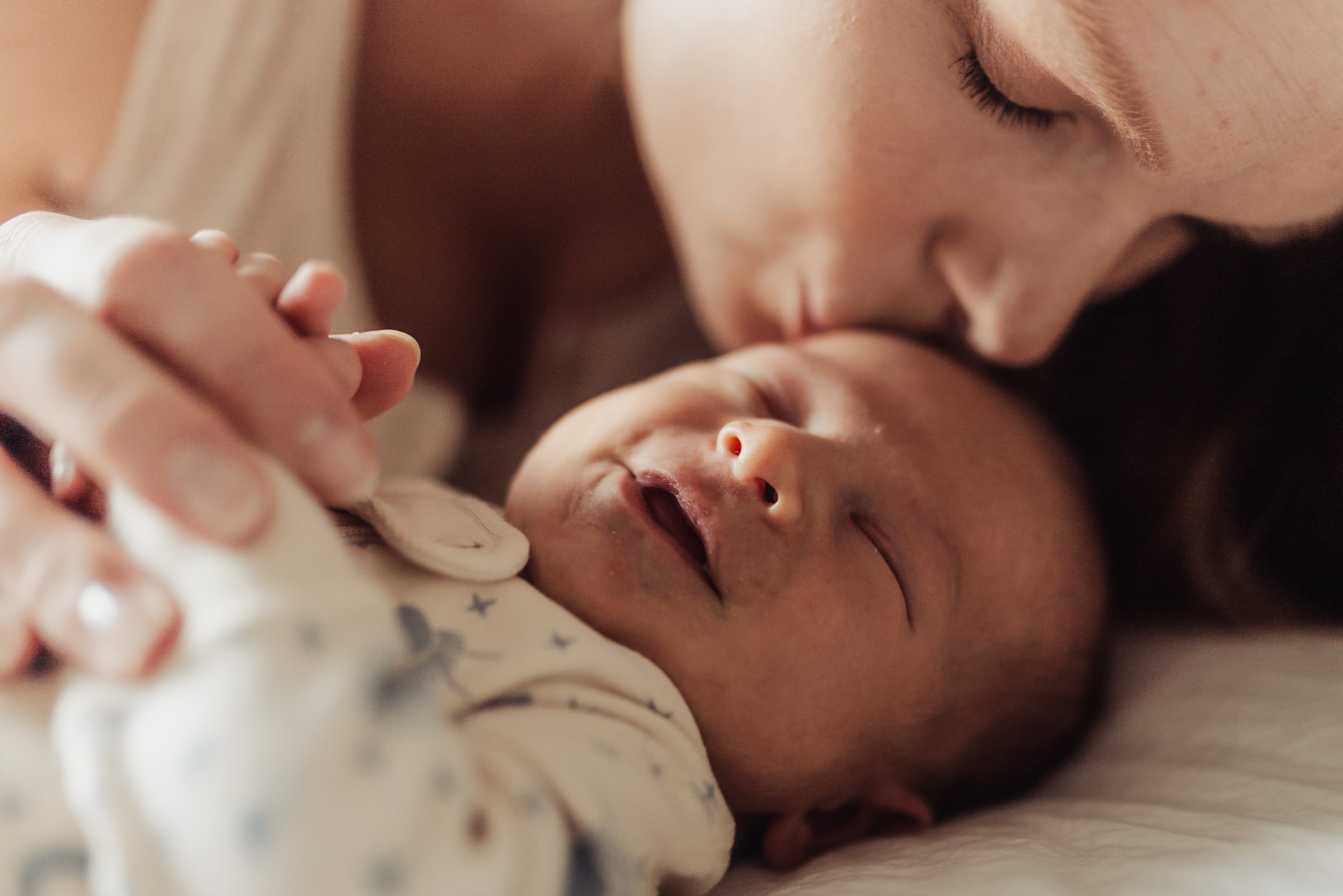 San Diego newborn photography, parent with a sleeping baby
