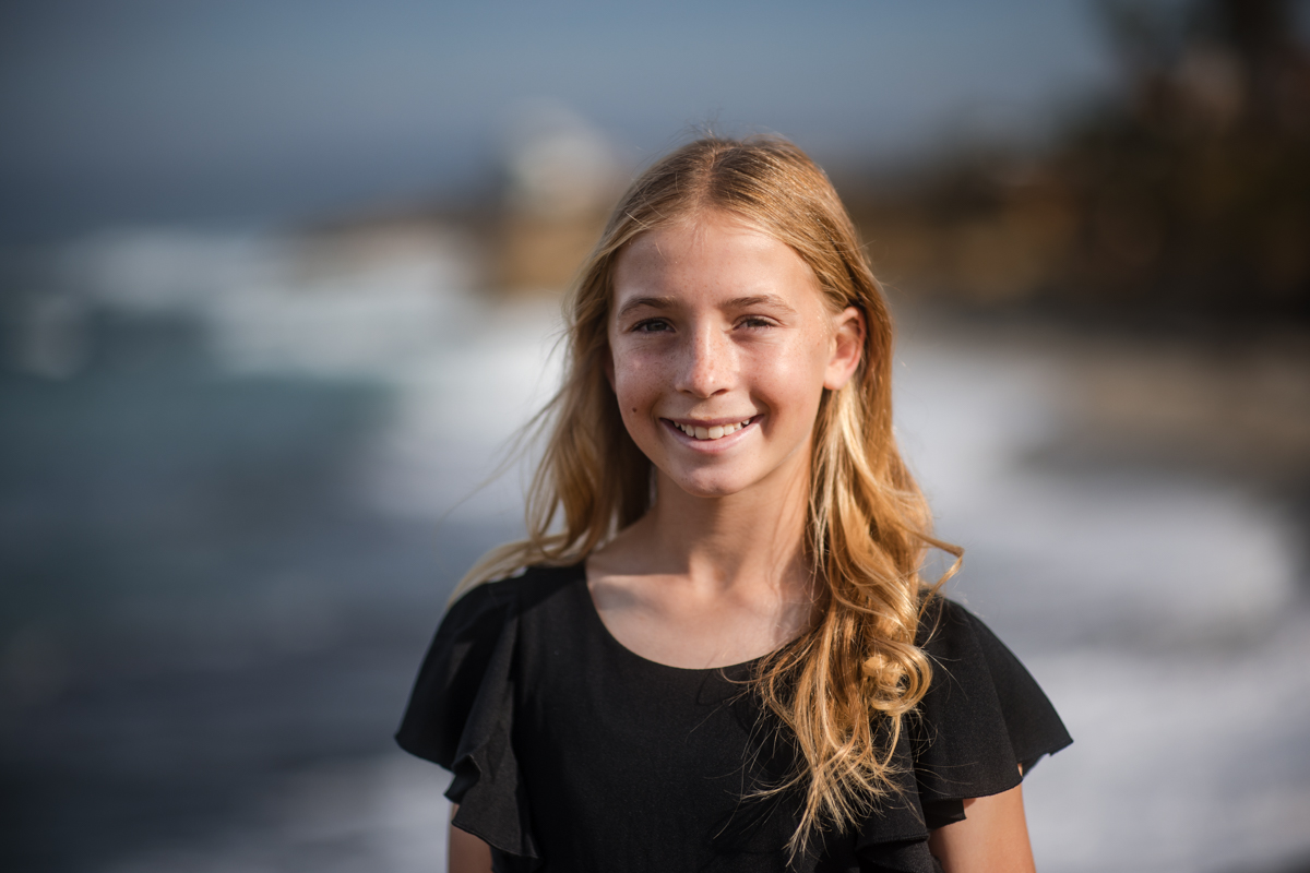Girl photographed by the ocean during an outdoor portrait session