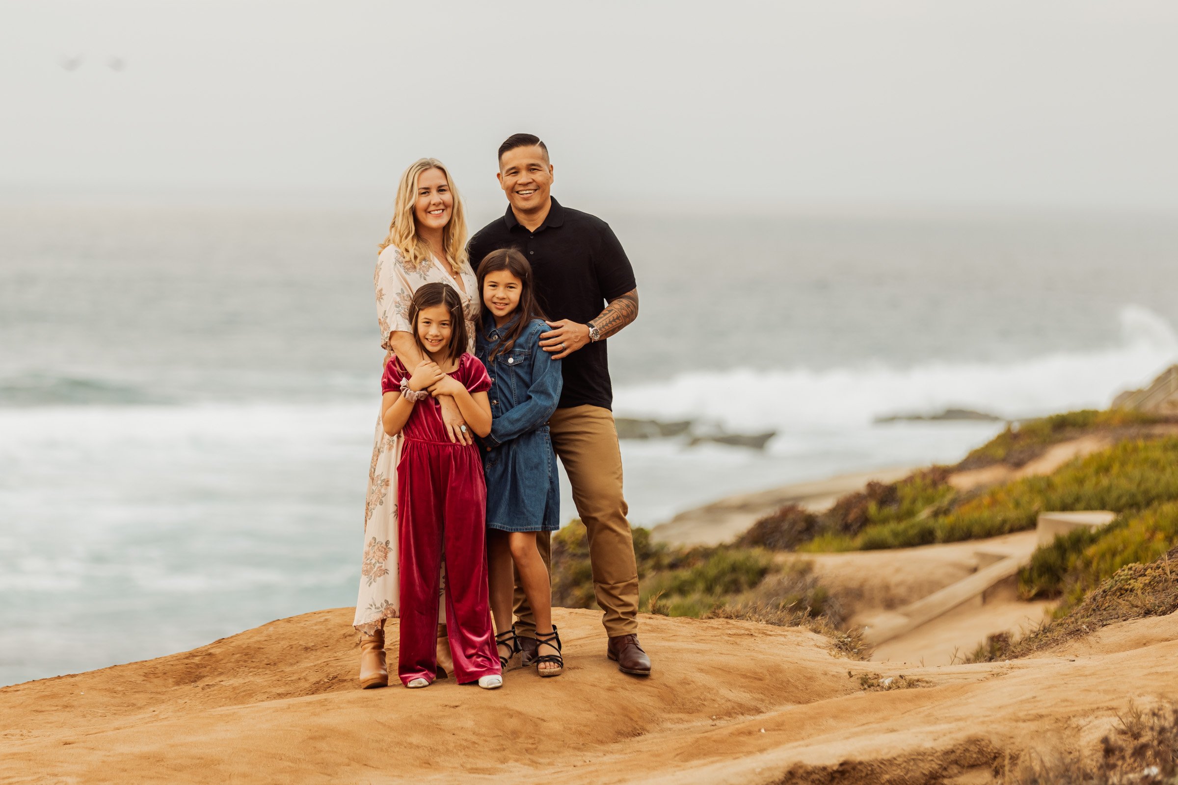 Family on the sandstone cliffs above the ocean in La Jolla, San Diego