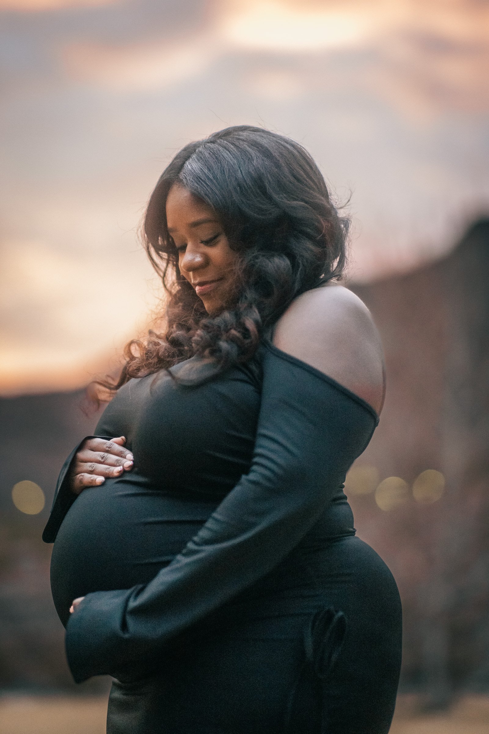 Maternity portrait at dusk in a black off-the-shoulder gown in Henderson, near Las Vegas